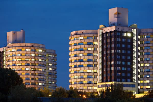 Two tall tower buildings of the Muenster University Clinic hospital at night, Germany.